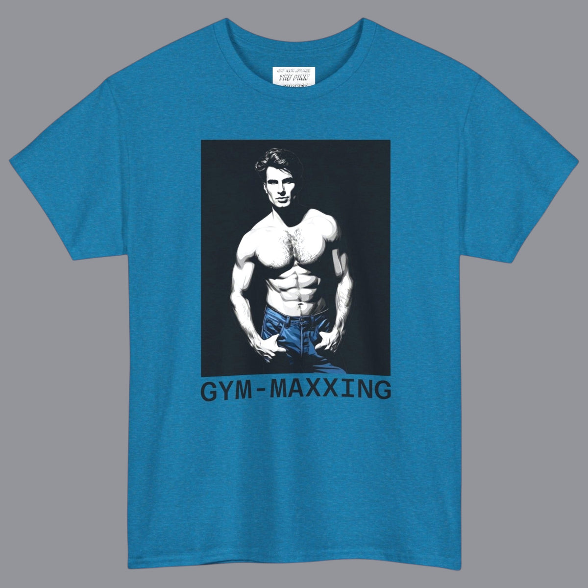 A teal blue short-sleeve t-shirt with a graphic print of a gay muscular shirtless man wearing blue pants, with the text 'GYM-MAXXING' printed below the graphic. Designed and for sale in The Pink Rocket New Orleans gay gift shop.