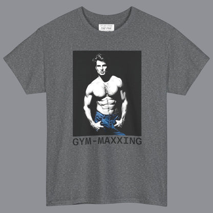 A heather gray short-sleeve t-shirt with a graphic print of a gay muscular shirtless man wearing blue pants, with the text 'GYM-MAXXING' printed below the graphic. Designed and for sale in The Pink Rocket New Orleans gay gift shop.