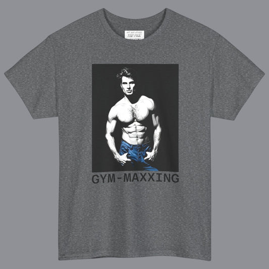A heather gray short-sleeve t-shirt with a graphic print of a gay muscular shirtless man wearing blue pants, with the text 'GYM-MAXXING' printed below the graphic. Designed and for sale in The Pink Rocket New Orleans gay gift shop.