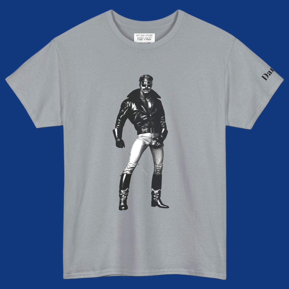 A gray short-sleeve t-shirt featuring a Tom of Finland style black and white graphic image of a gay biker with a leather jacket and boots with his hand on his large bulge. Sold in The Pink Rocket New Orleans gay gift shop.