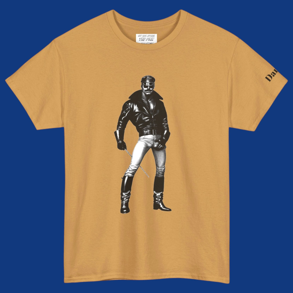 A gold short-sleeve t-shirt featuring a Tom of Finland style black and white graphic image of a gay biker with a leather jacket and boots with his hand on his large bulge. Sold in The Pink Rocket New Orleans gay gift shop.