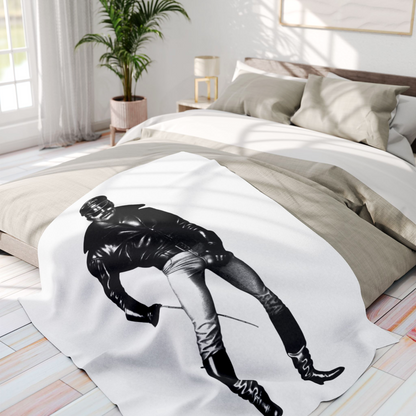 A black and white Tom of finland style image of a muscular gay man wearing a black leather jacket, aviator sunglasses, light-colored pants, and tall black boots, holding a thin rod. Designed and for sale in The Pink Rocket New Orleans gay owned small business.