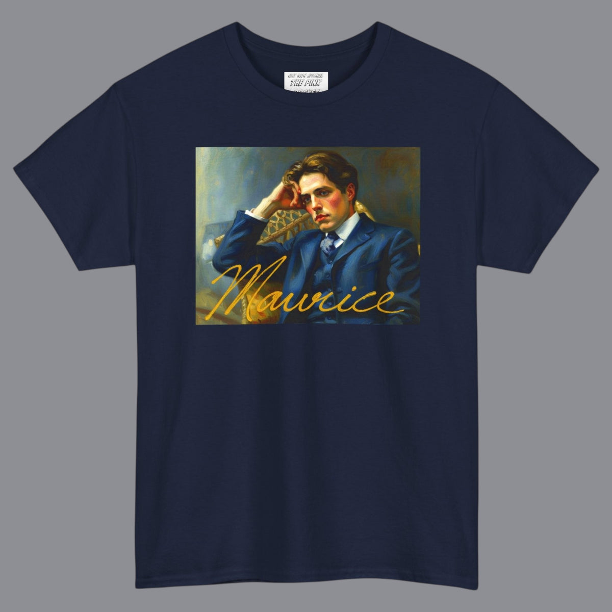 A navy blue short-sleeve t-shirt with a rectangular graphic print of the gay 80's film Maurice on the chest depicting a portrait of a man in a blue suit and the name 'Maurice' in gold script. Designed and available in The Pink Rocket New Orleans gay gift shop.