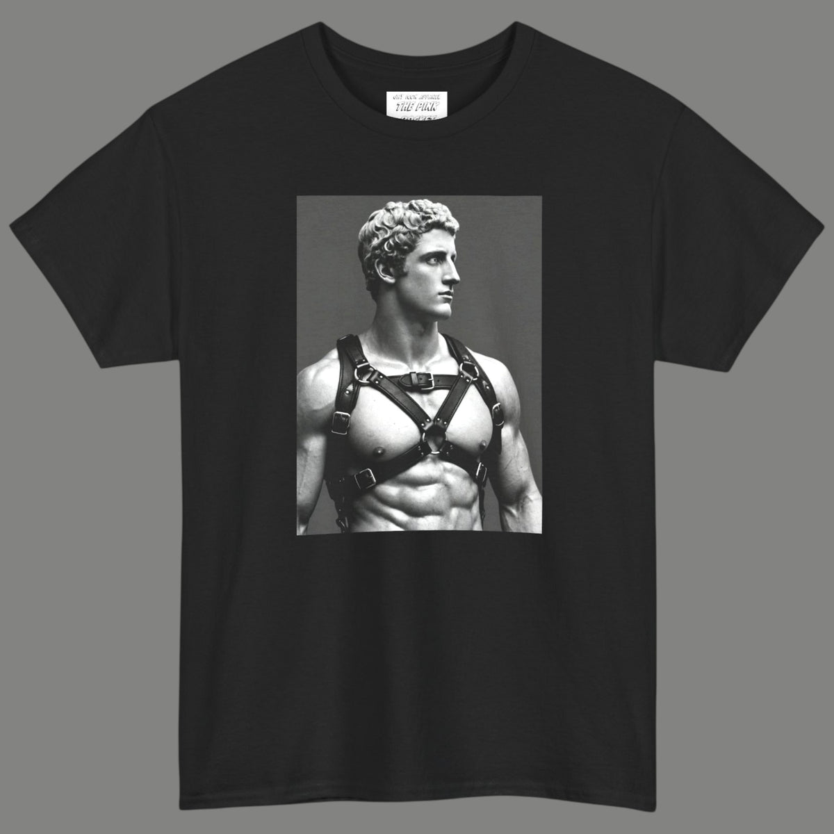 A black crewneck t-shirt featuring a black-and-white graphic print of a muscular classical Apollo statue wearing a harness. Designed and sold in The Pink Rocket New Orleans gay owned gift shop.