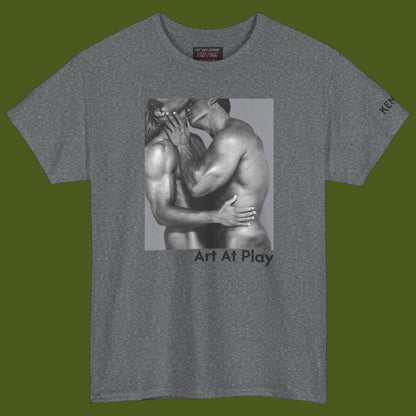 A heather gray crewneck t-shirt featuring a black and white graphic print of a nude gay male couple embracing and kissing, with the text 'Art At Play' printed below the image. Designed and for sale in The Pink Rocket ew Olreans gay gift shop.