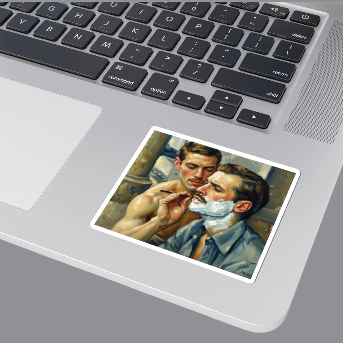 An oil painting laptop sticker depicting a bearded gay man with white shaving foam while another man shaves his face. Designed and sold in The Pink Rocket New Orleans gay owned gift shop.