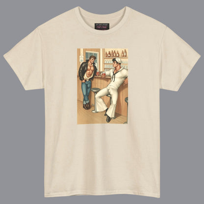 An off white beige crewneck t-shirt featuring a vintage-style graphic print of hunky gay two men in a bar. For sale in The Pink Rocket New Orleans gay owned gift shop.